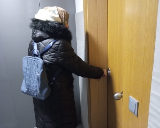 Una mujer abriendo la puerta de una casa